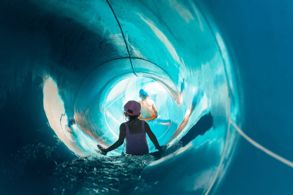 Children inside large slide at water park.
